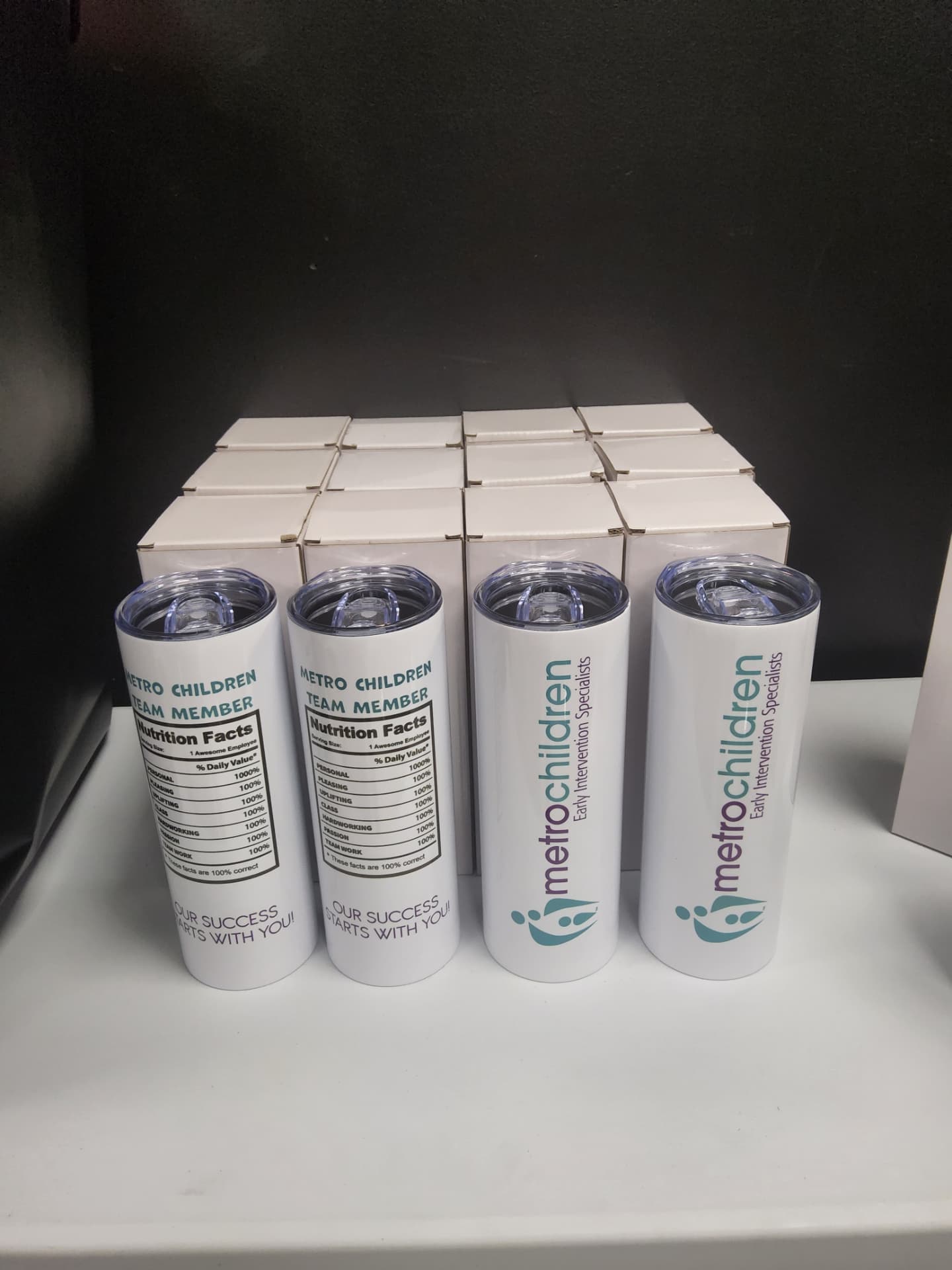 Metro Children branded white tumblers with team member nutrition facts print