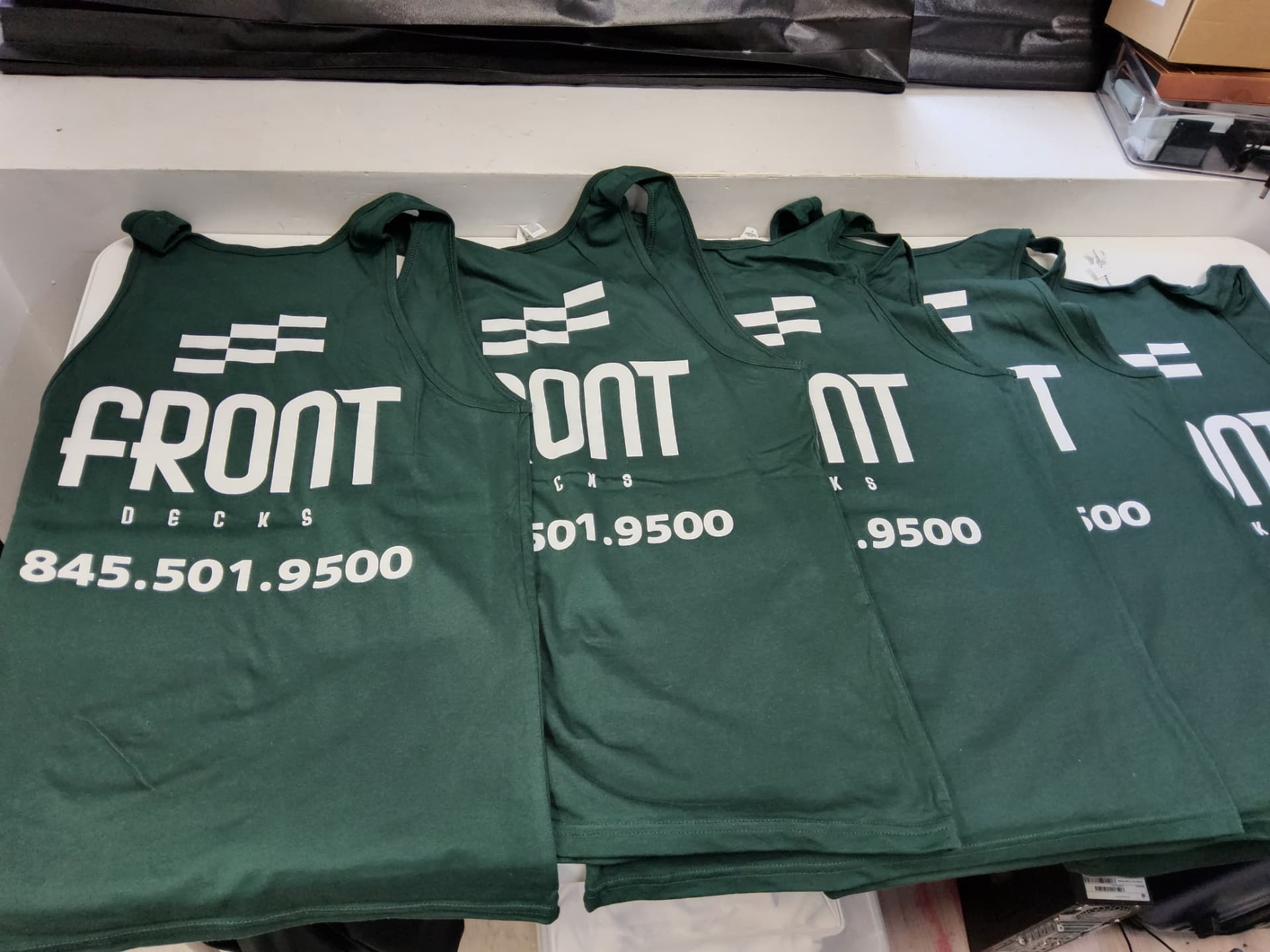 Front Decks green crew tank tops with screen printed logo