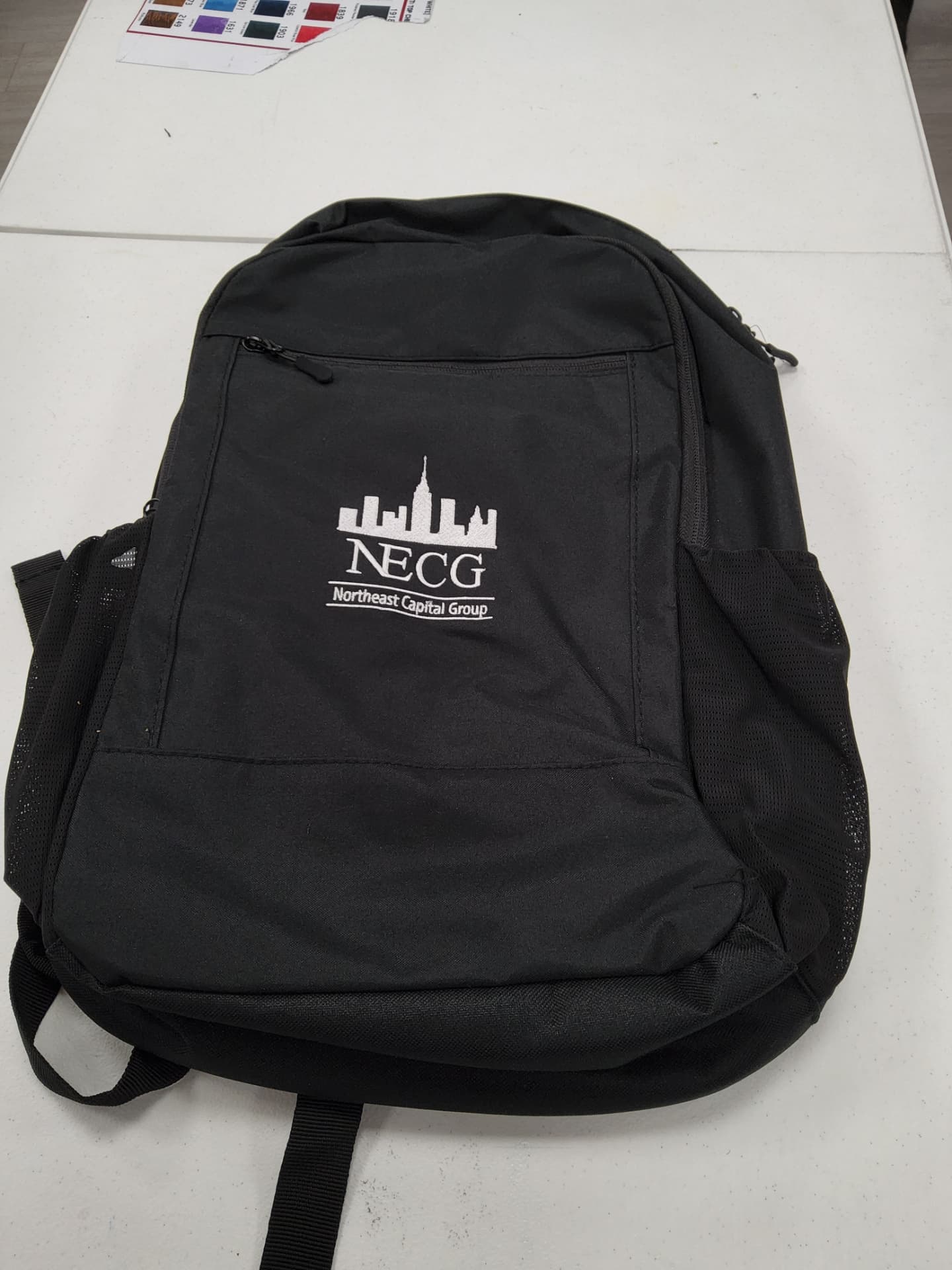Northeast Capital Group black backpack with white embroidered skyline logo