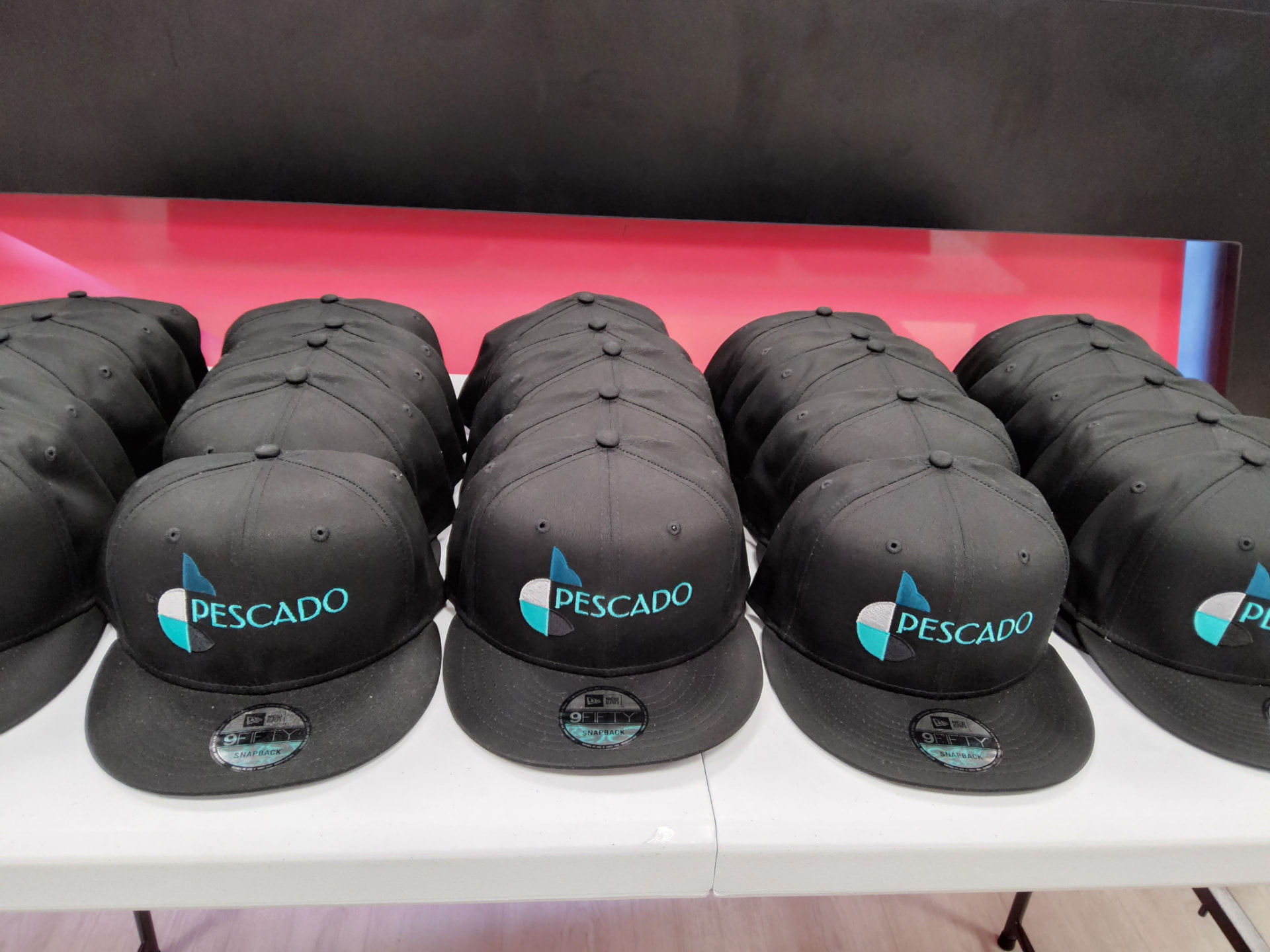 Pescado black snapback caps with teal embroidered logo