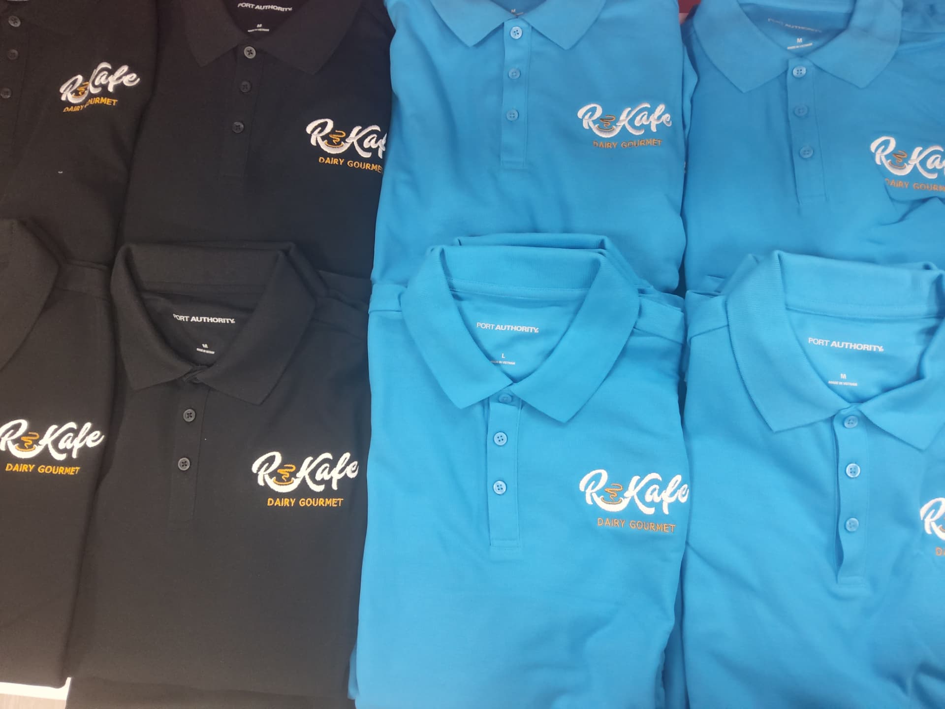 R Kafe Dairy Gourmet embroidered black and blue polos
