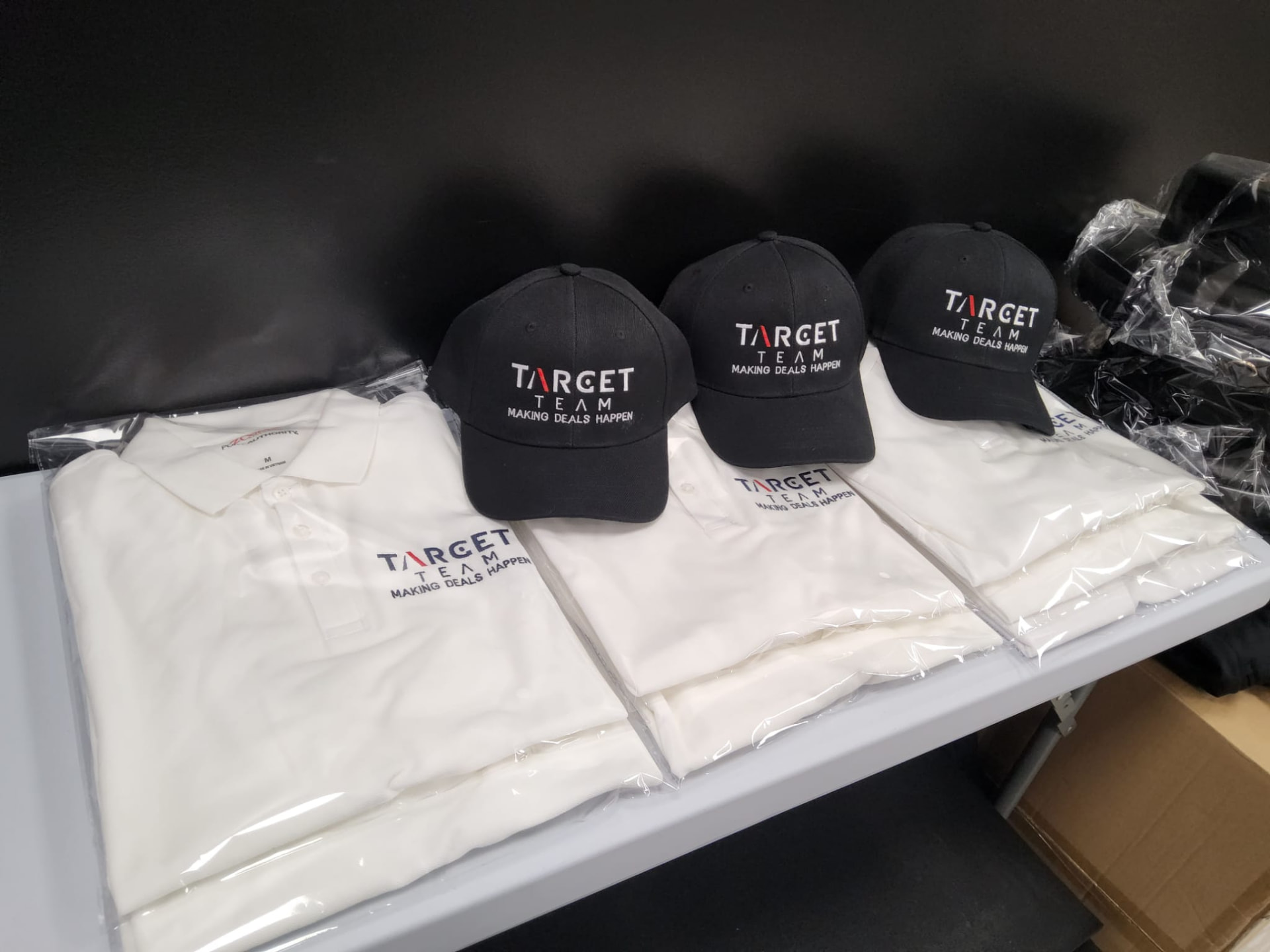Target Team white embroidered polos and black caps