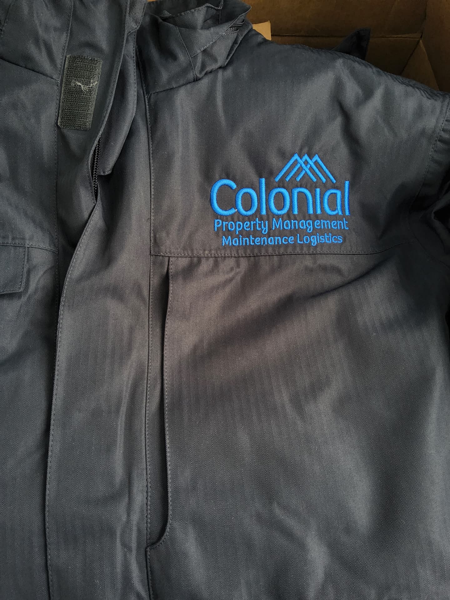 Colonial Property Management jacket with blue embroidered left-chest logo